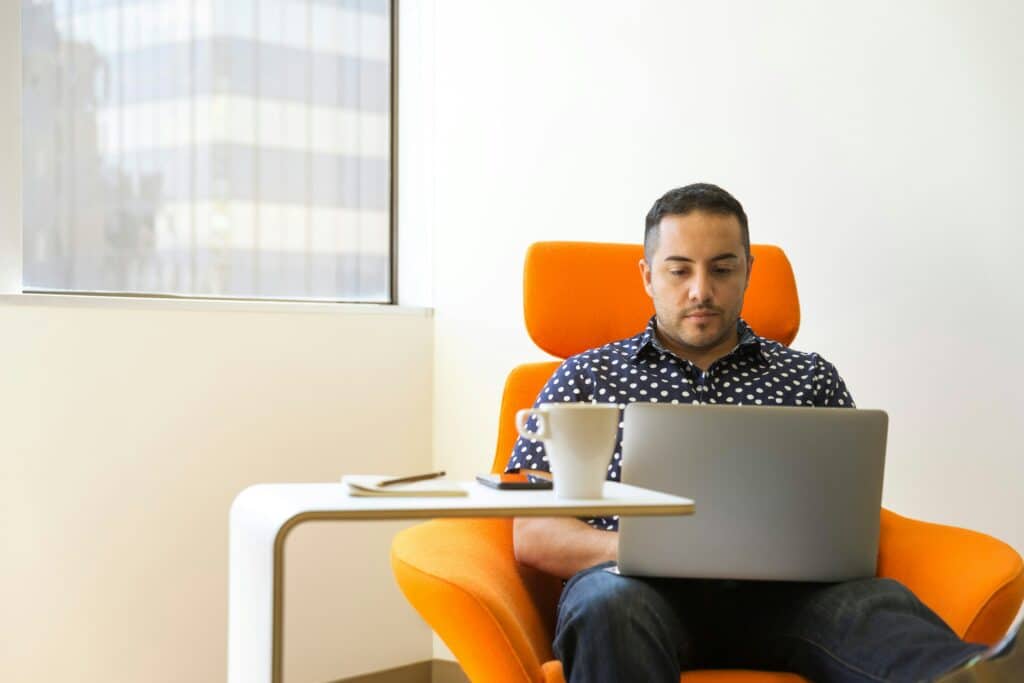 guy working in orange chair