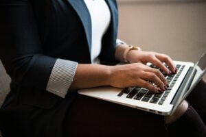 woman typing on laptop