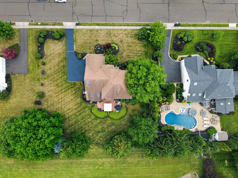 Top-down aerial photo of a house with a backyard pool