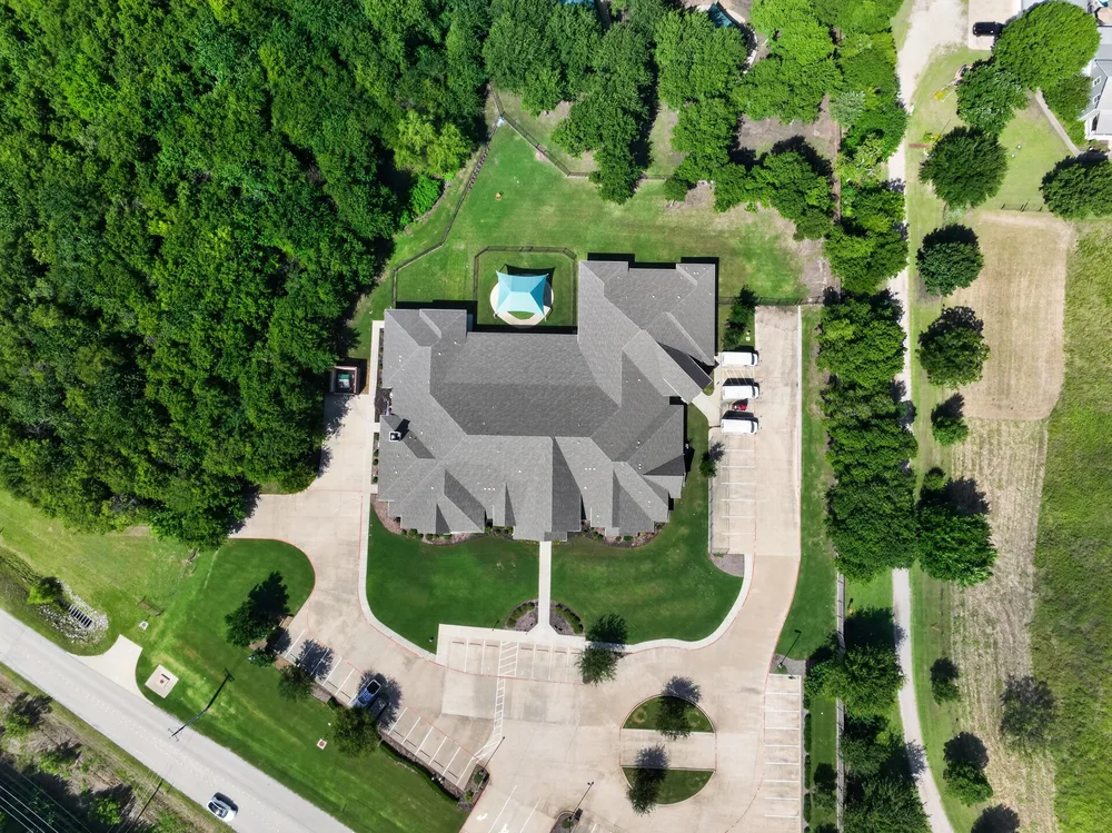 Aerial drone photograph of a home and its lot, the kind of marketing asset that comes after listing prep is complete