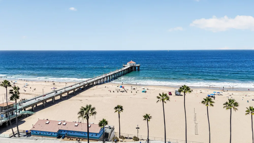 Aerial view of a coastline and pier, an example of the professional media captured once a listing is ready to market