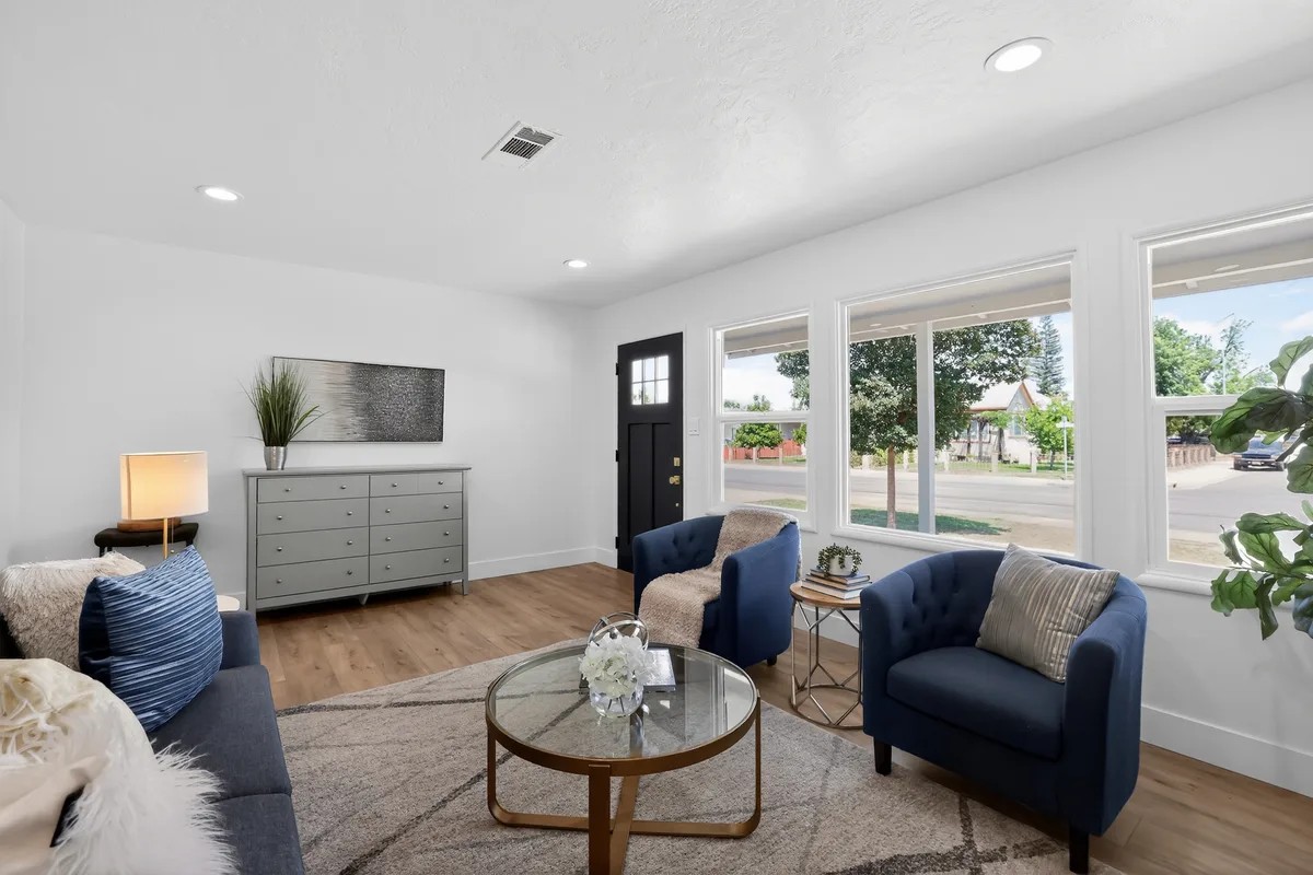 A staged living room with an entry door, ready to be shown after the property was prepared for sale