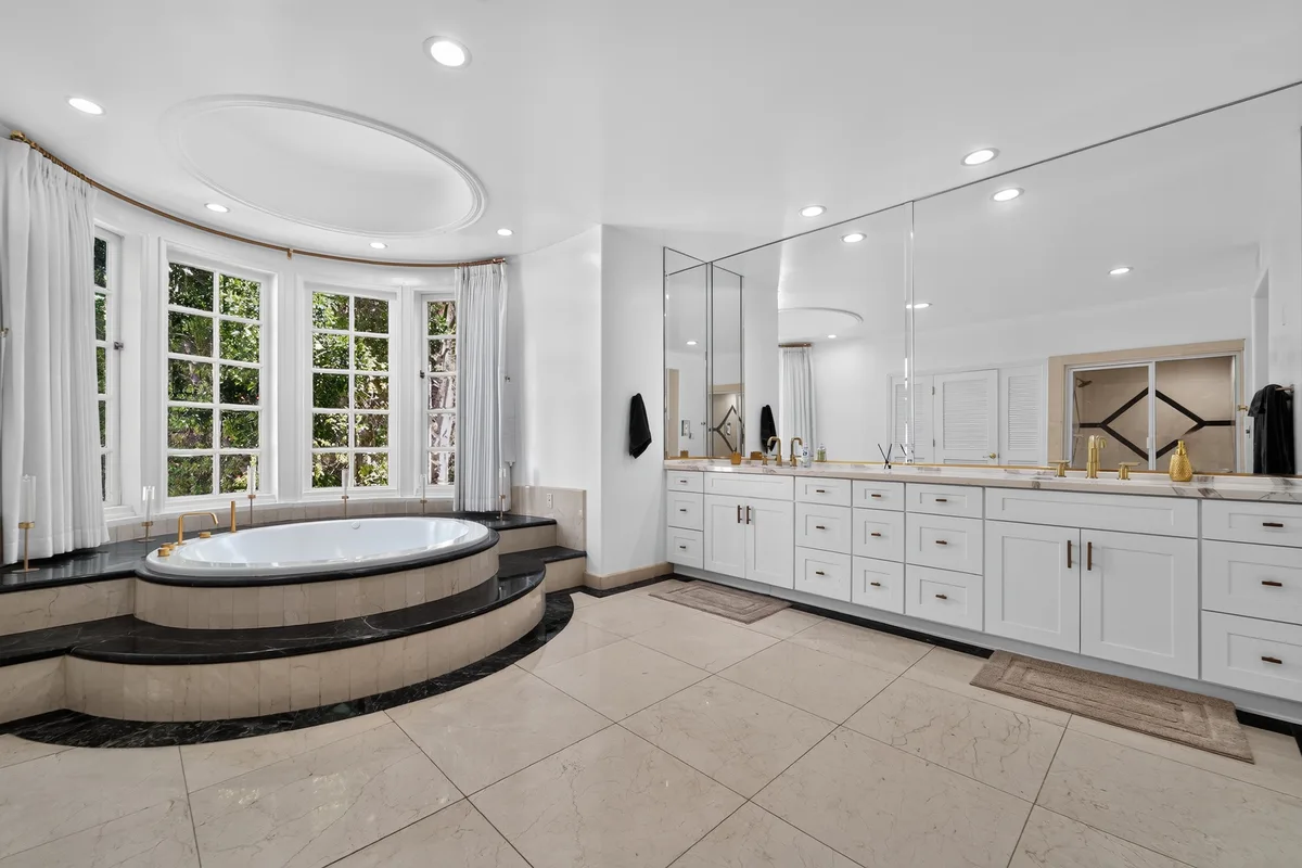 A primary bathroom with a bay window and soaking tub, prepared and staged ahead of a listing photo shoot