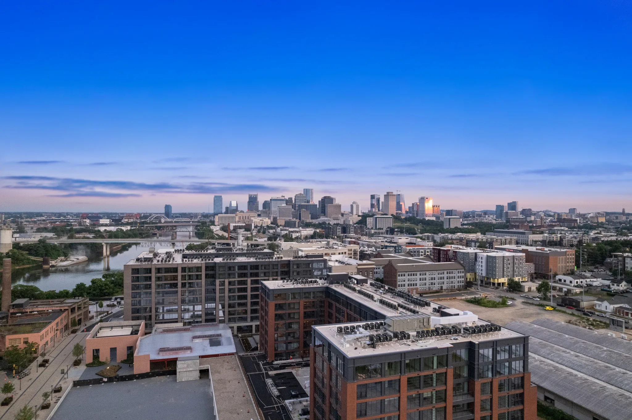 Aerial drone photo of a downtown skyline at sunset