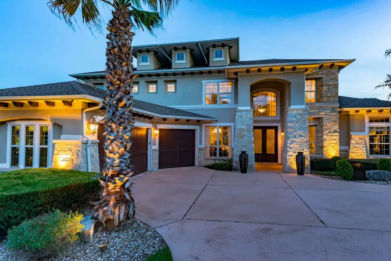 Residential property at twilight with warm interior glow