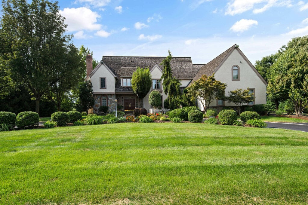 Out door view of a large home with a big yard. - HomeJab