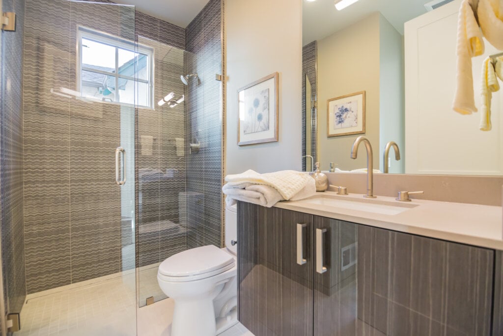 Bathroom with glass walk in shower and single faucet. - HomeJab