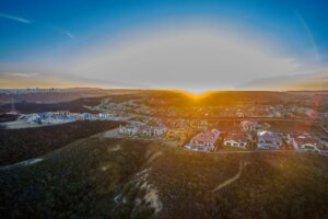 Areal drone photograph of a neighborhood at sunset. 