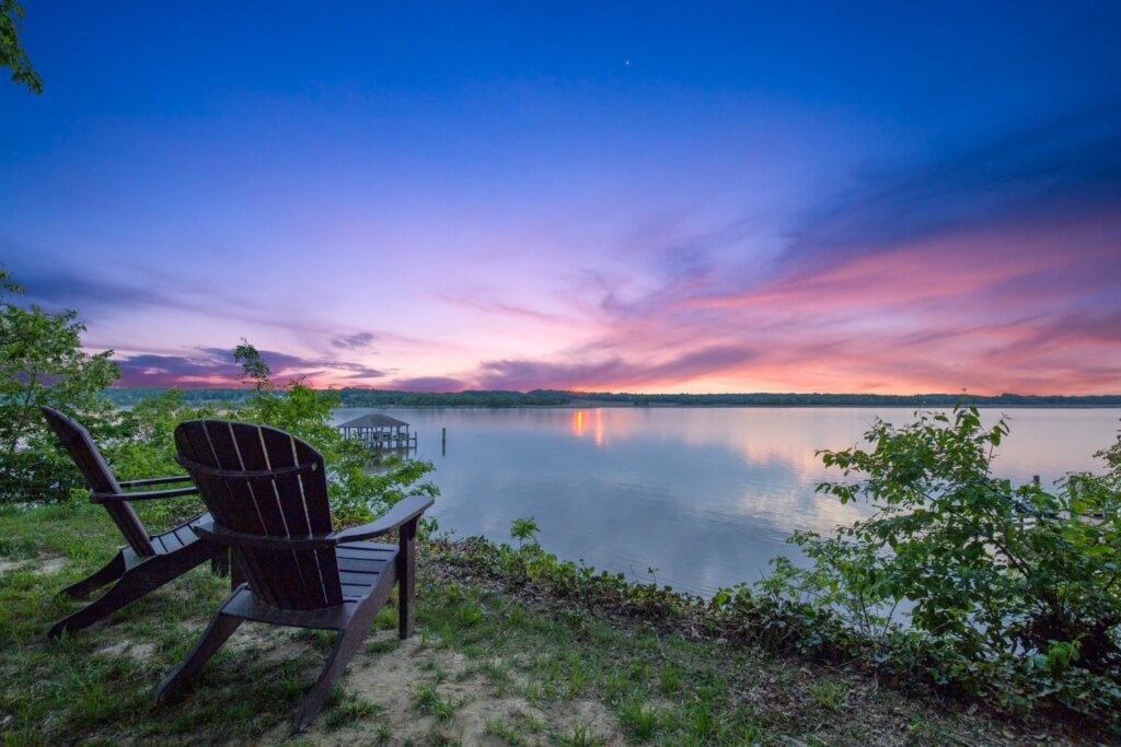 Two chairs overlooking a lake and shot using HomeJab's Virtual Dusk photography.