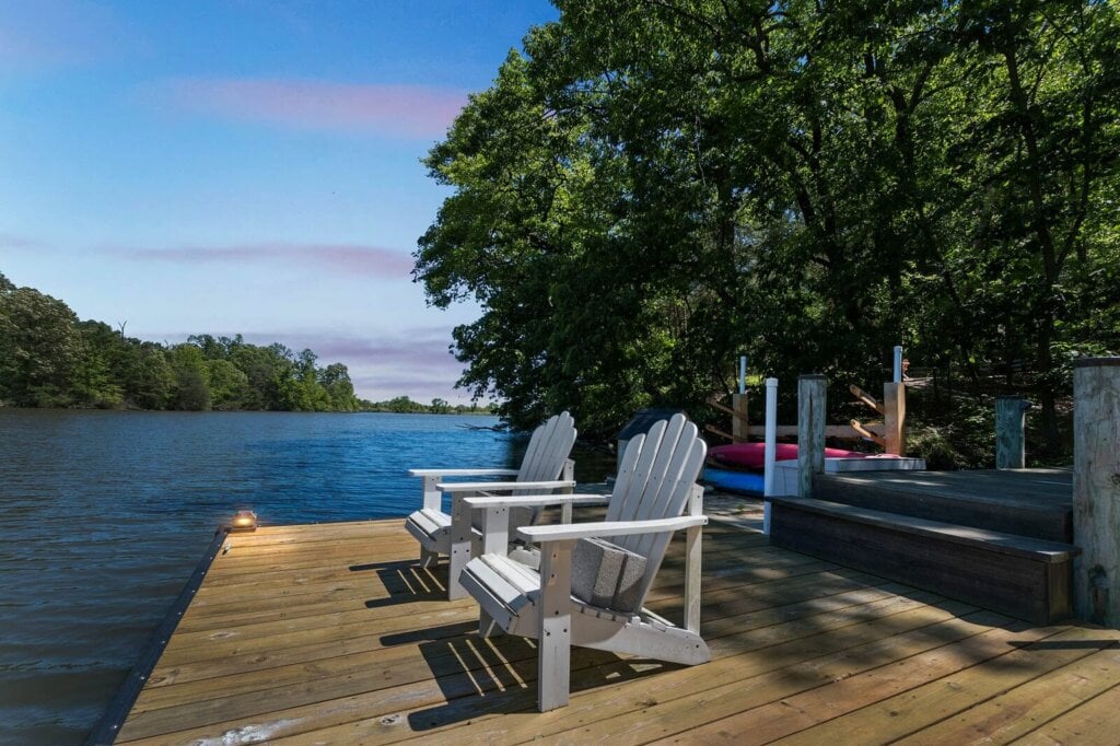 River dock with two white chairs. - HaomeJab