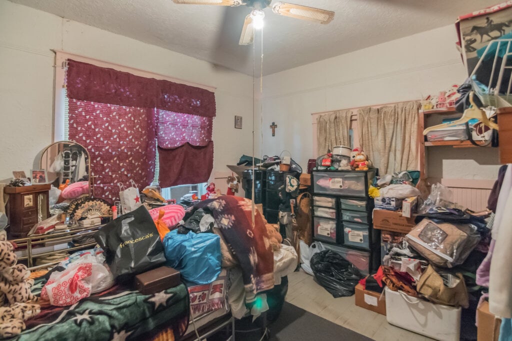Image of an over cluttered bedroom. - HomeJab