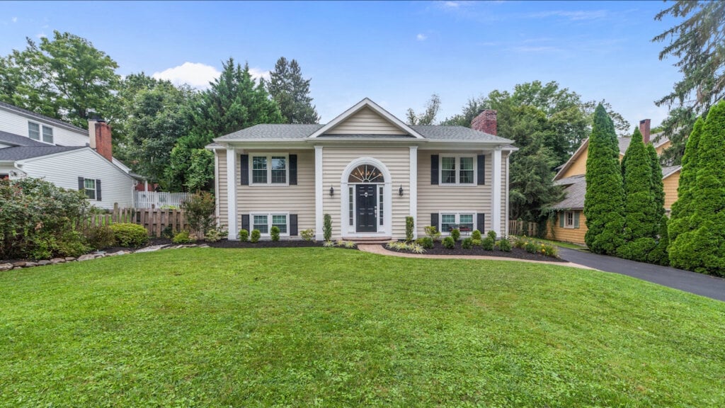 Curbside photo of a large home with beige siding using HomeJab's blue shy replacement.