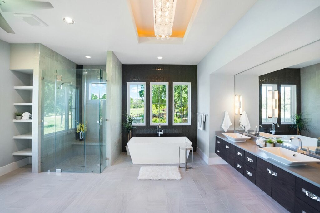Interior photo of a modern spacious bathroom with two sinks, a soaking tub and shower.
