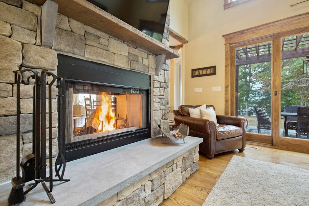 Close up photo of a living room fireplace that is exposed on both sides.