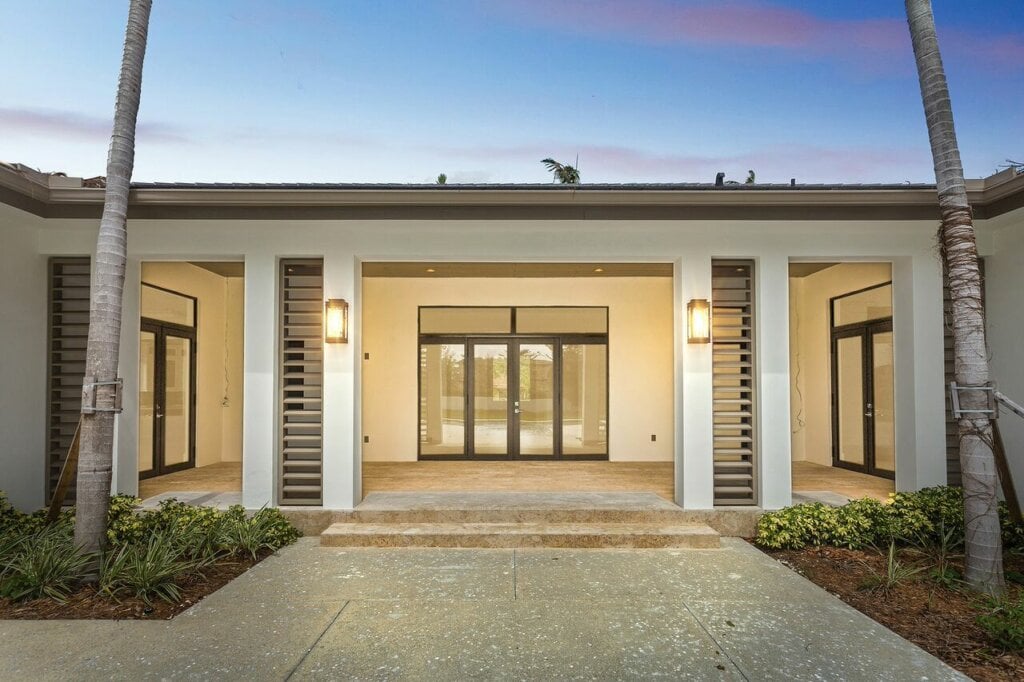 Front entryway of a white house with windows as doors. - HomeJab