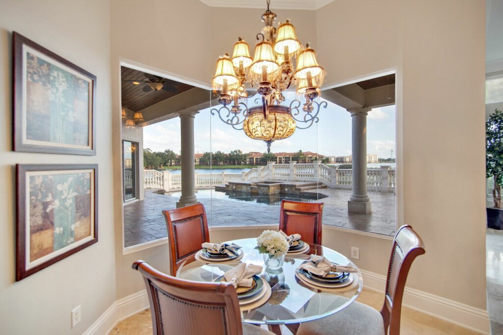 Corner dining nook with seats for four in front of a large window.