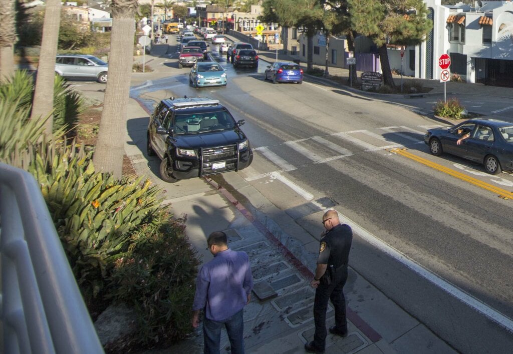 Man talking with police officer on the side walk. - HomeJab