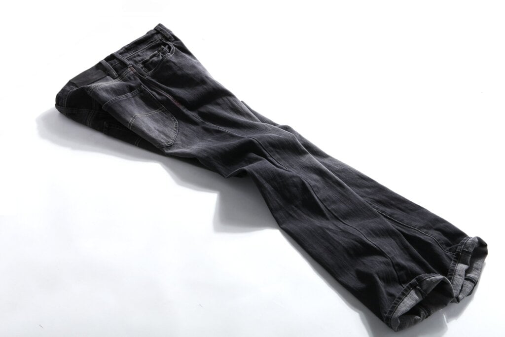 Pair of black denim jeans on the floor. - HomeJab