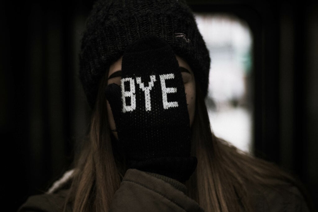 Girl Covering her face with bye on her glove. - HomeJab