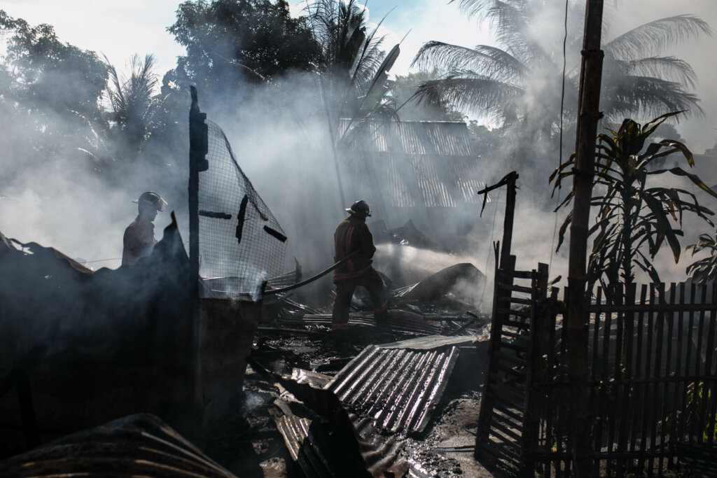 Firefighters walking over a burned out area. - HomeJab