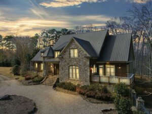 Two story stone house photographed at sunset. - HomeJab