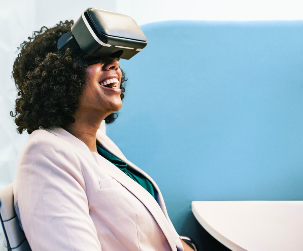 Woman looking through a pair of virtual reality goggles. - HomeJab