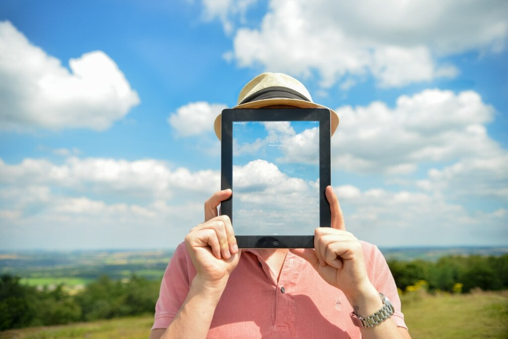 Person with an iPad to his face. - HomeJab