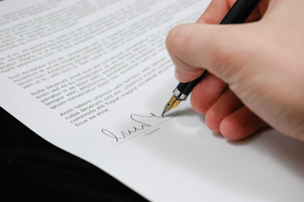 Person signing a document. - HomeJab