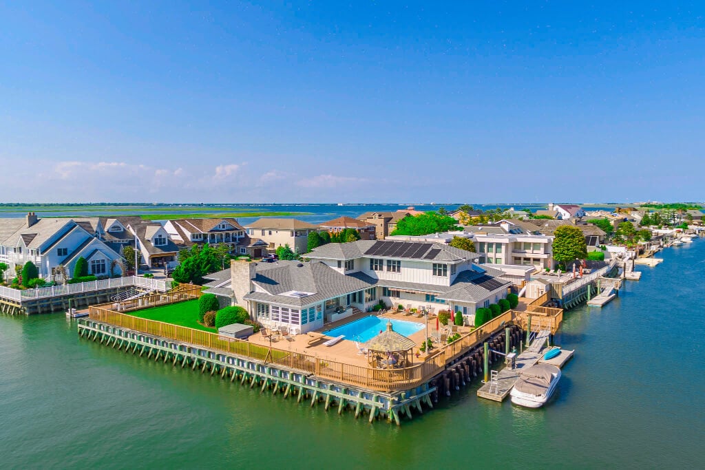 Drone photo of houses built with docks overlooking the ocean.