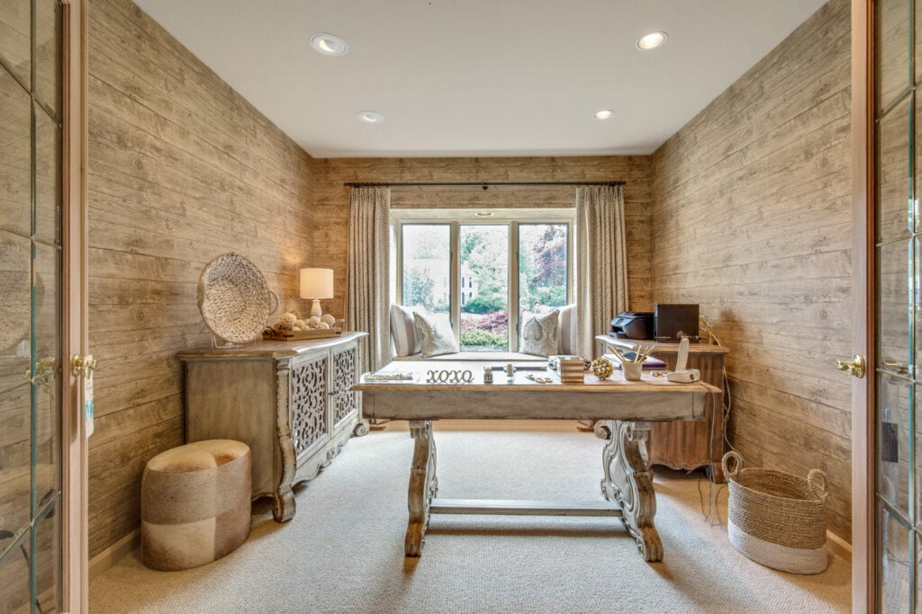 Home office area with wood walls and decorative desk. - HomeJab