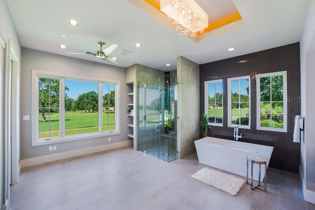 Large open bathroom with soaking tub, separate shower and picture window. - HomeJab