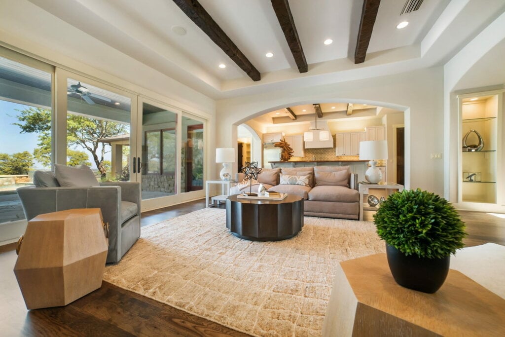 Large white livingroom with wood floors, white walls and abstract décor. - HomeJab