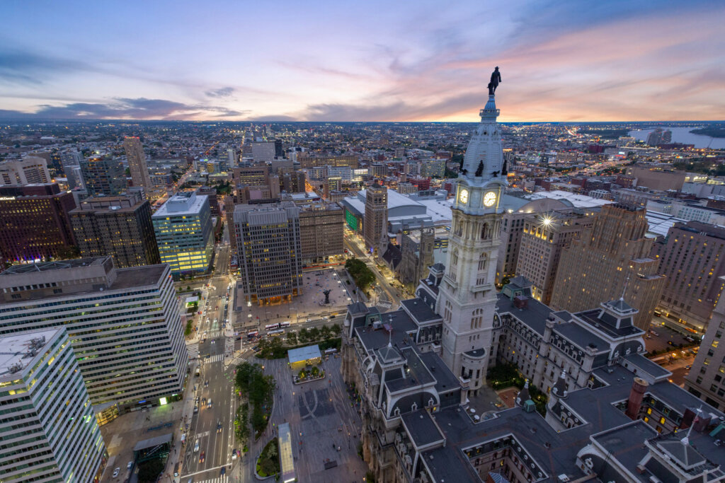 Areal drone photograph of a city at dusk.