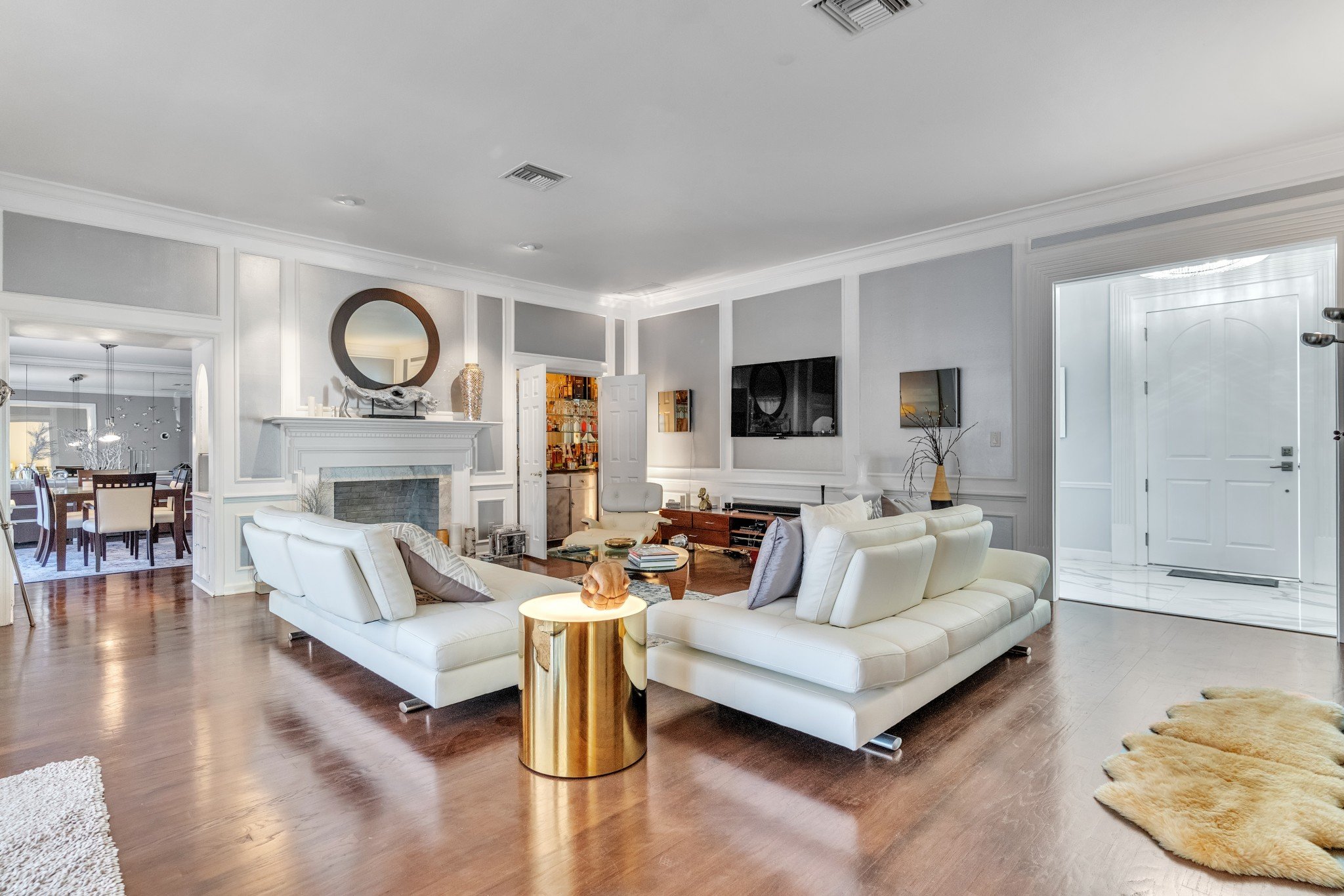 Large grey and white living room with wood floor - HomeJab