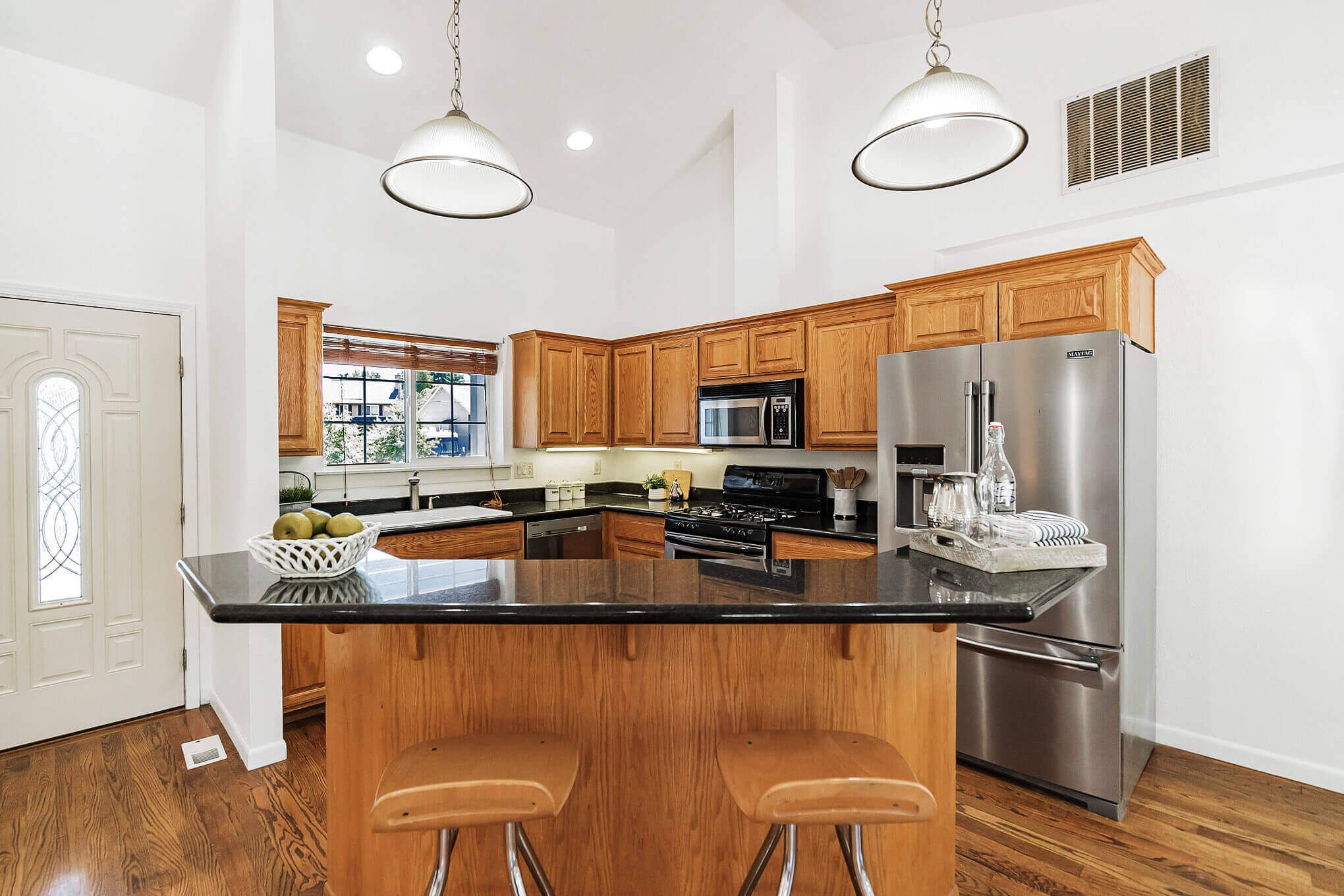 Large kitchen with tan wood cabinets and wood floors in Vernonia, OR